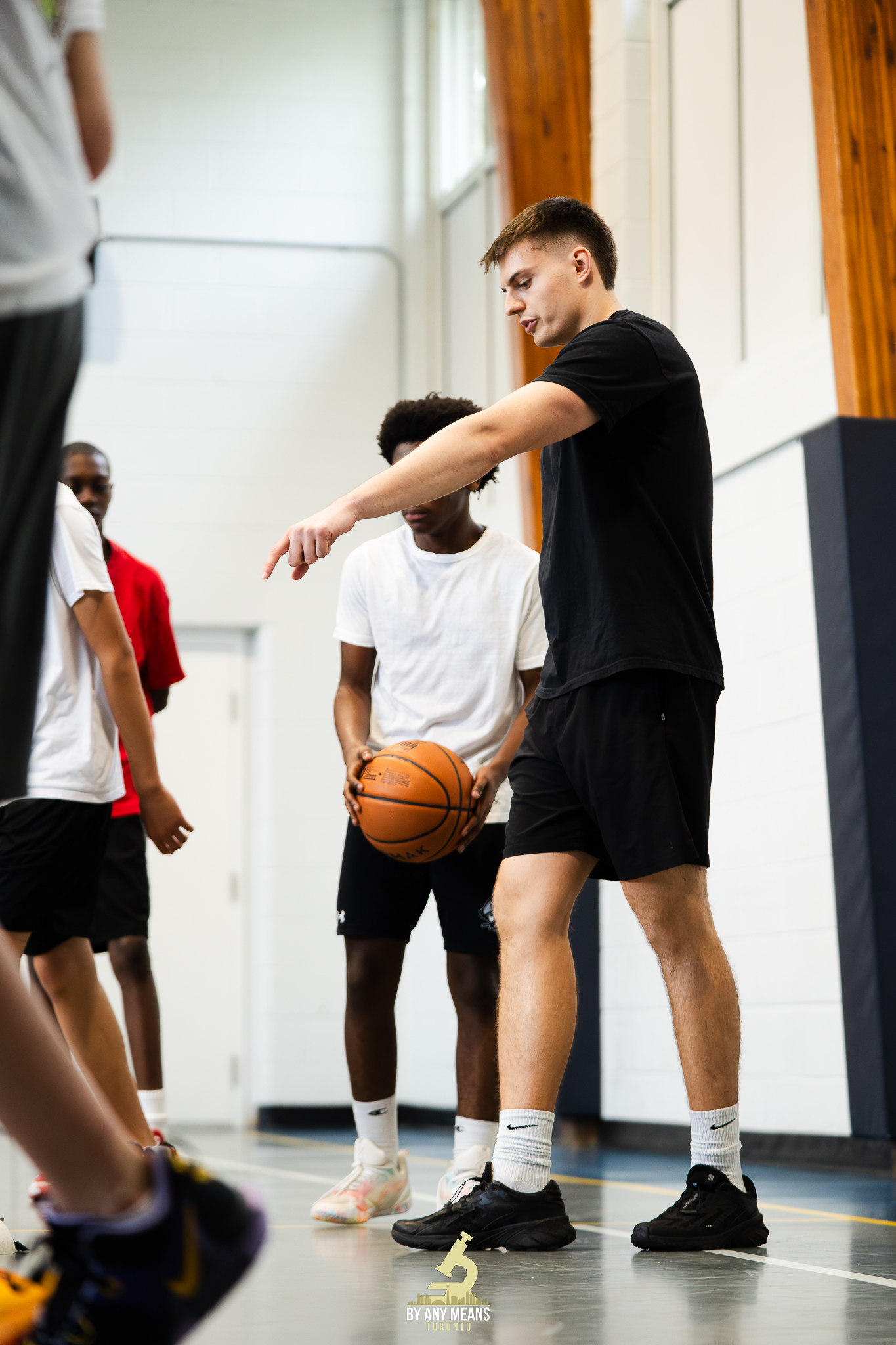 A BAM GTA coach teaching young players during a training session